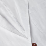 Close-up of the Men's White Nassau Linen Jacket showcasing its lightweight linen fabric and signature corozo nut button.