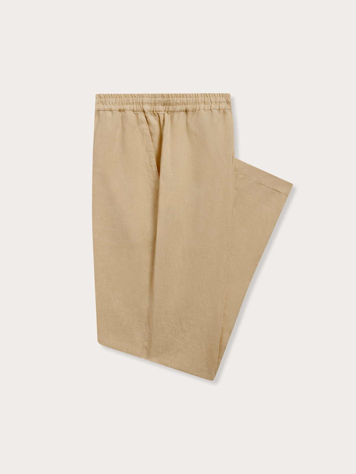 Side view of Men's Coconut Eleuthera Linen Trousers. Beige linen pants for men with 2 front pockets, drawstring tie and elastic waist in a relaxed fit.