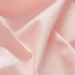 Detailed view of 100% cotton fabric of mens pastel pink chinos.