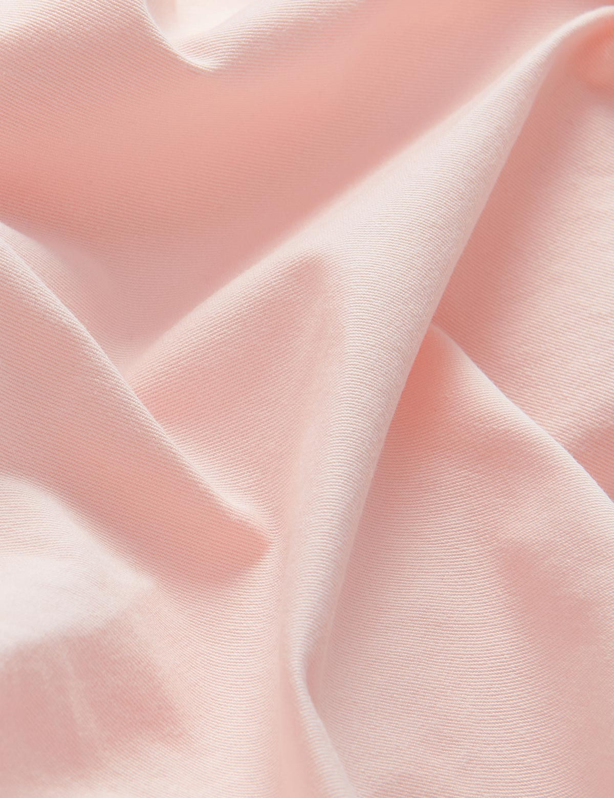 Detailed view of 100% cotton fabric of mens pastel pink chinos.