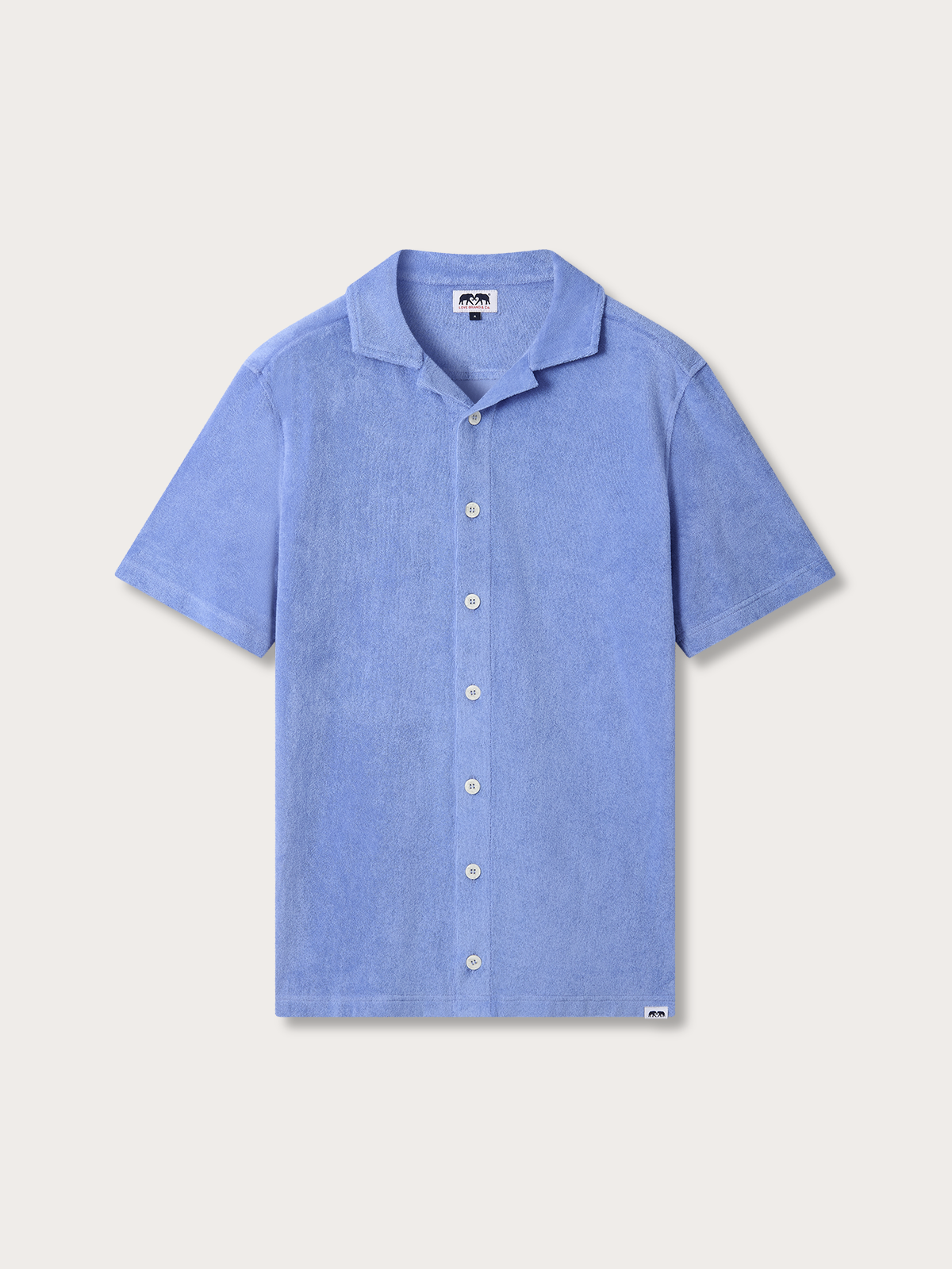 A light blue short-sleeve camp collar button-up shirt with white buttons, displayed flat against a light beige background.