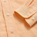 Detailed cuff view of Men's Orange Sorbet Abaco Linen Shirt. Long-sleeved button-up shirt made from 100% in orange.