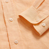 Detailed cuff view of Men's Orange Sorbet Abaco Linen Shirt. Long-sleeved button-up shirt made from 100% in orange.