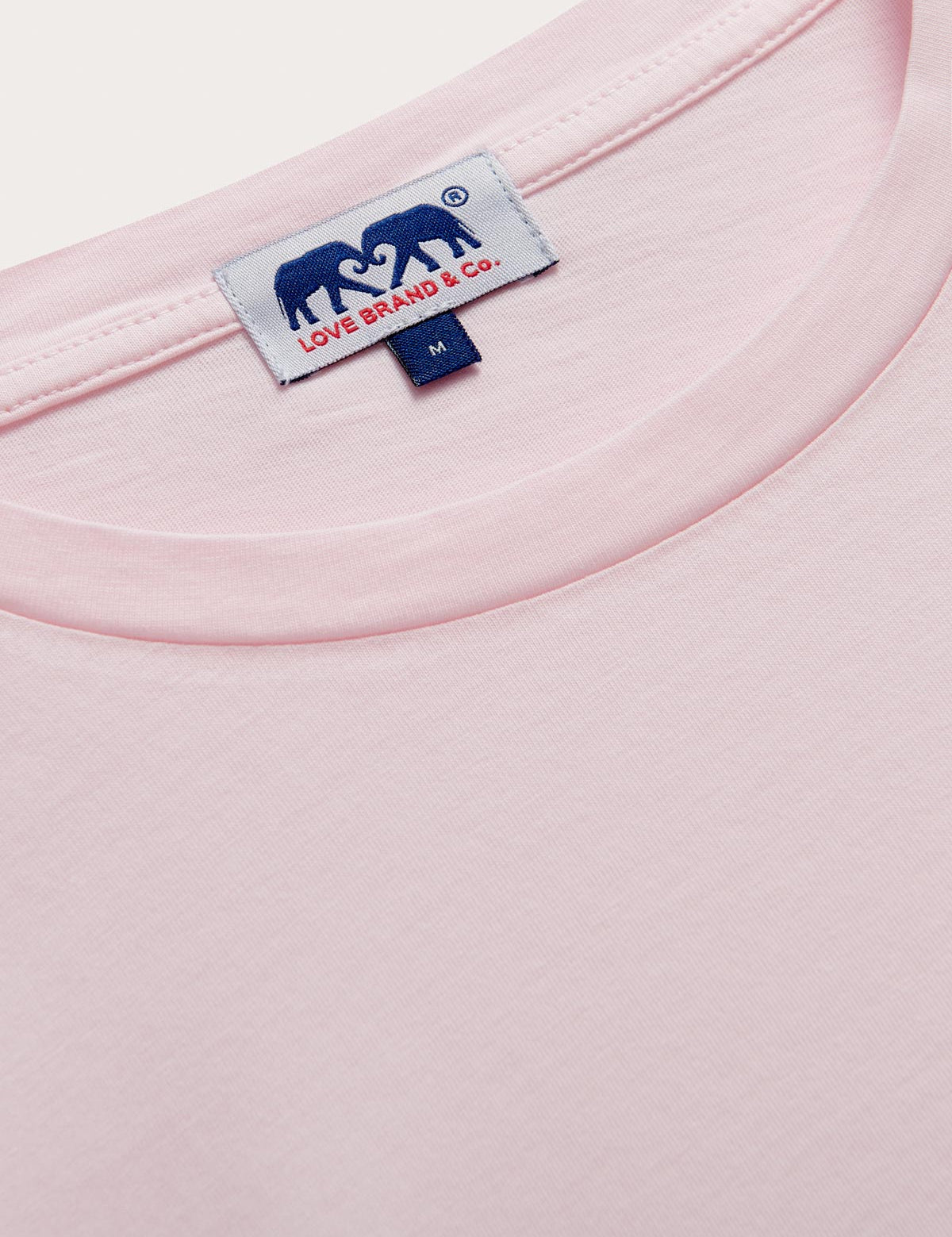 Collar view of Men's Pastel Pink Lockhart With Tab T-Shirt. Light pink t-shirt in a relaxed fit crafted from 100% cotton.