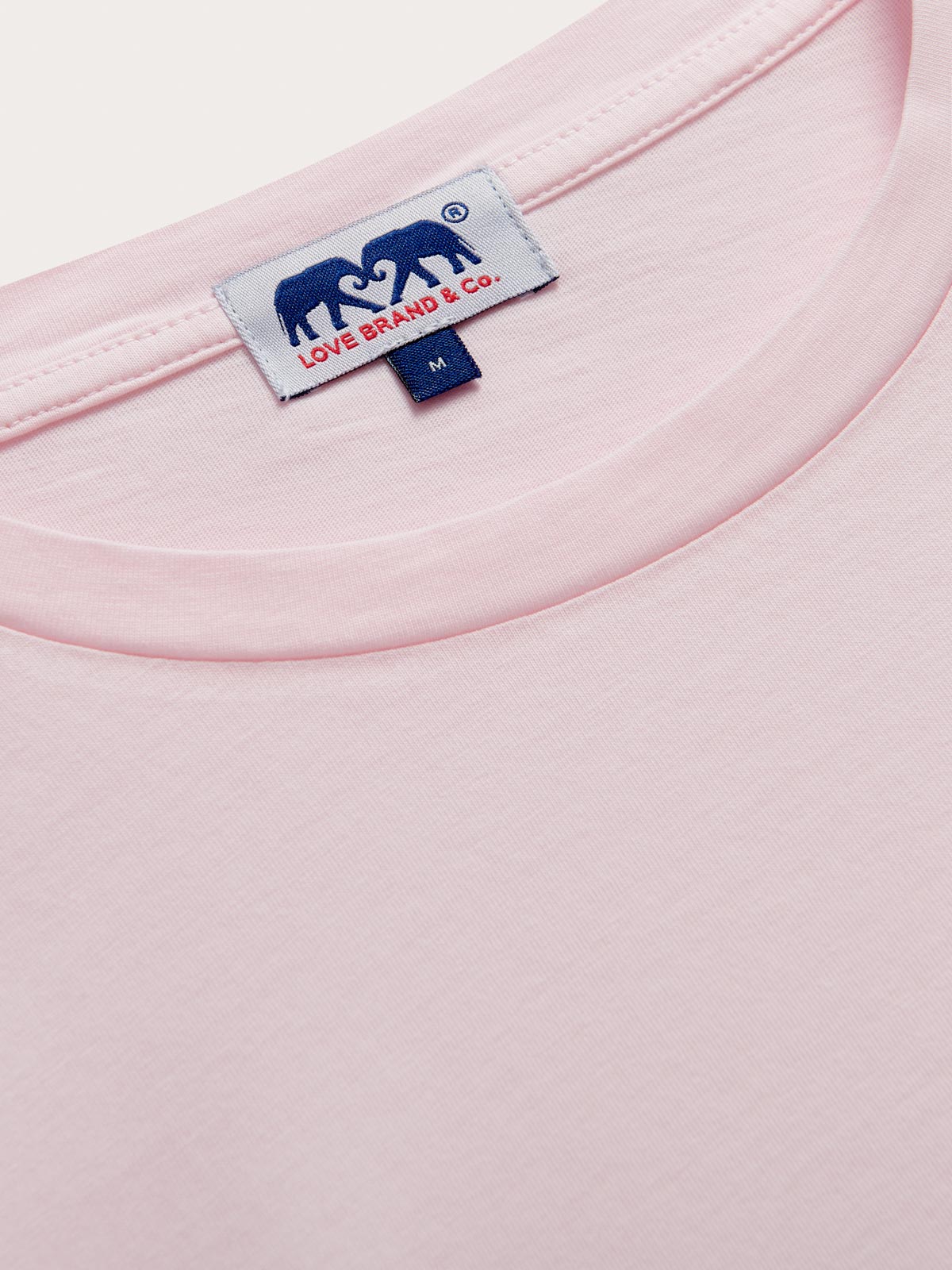 Collar view of Men's Pastel Pink Lockhart With Tab T-Shirt. Light pink t-shirt in a relaxed fit crafted from 100% cotton.