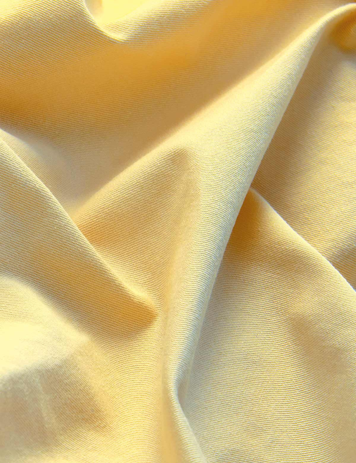 Close-up view of men's yellow shorts crafted from 100% cotton.