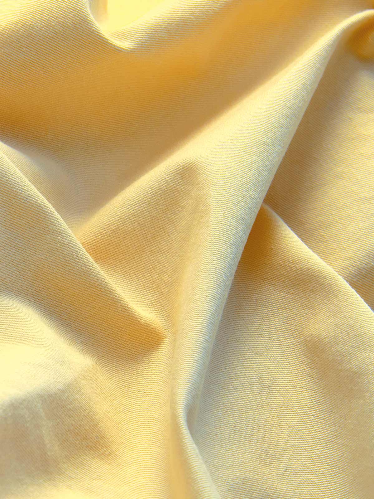 Close-up view of men's yellow shorts crafted from 100% cotton.