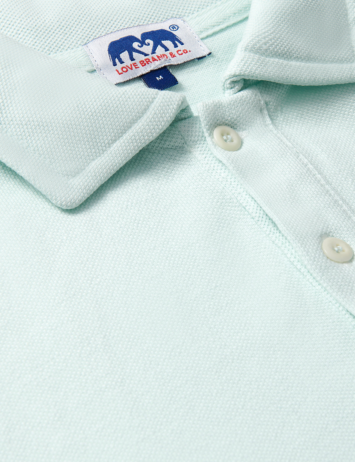 Close-up of the Men's Sea Air Pensacola Polo Shirt in pastel hue, featuring breathable cotton fabric and button details.