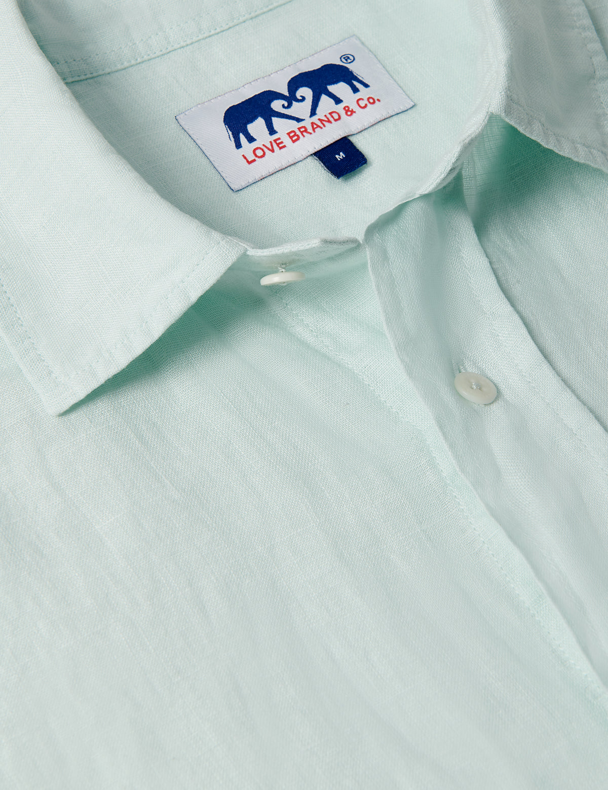 Close-up of the Men's Sea Air Manjack Linen Shirt in a subtle pastel hue, showcasing lightweight, breathable fabric and buttons.