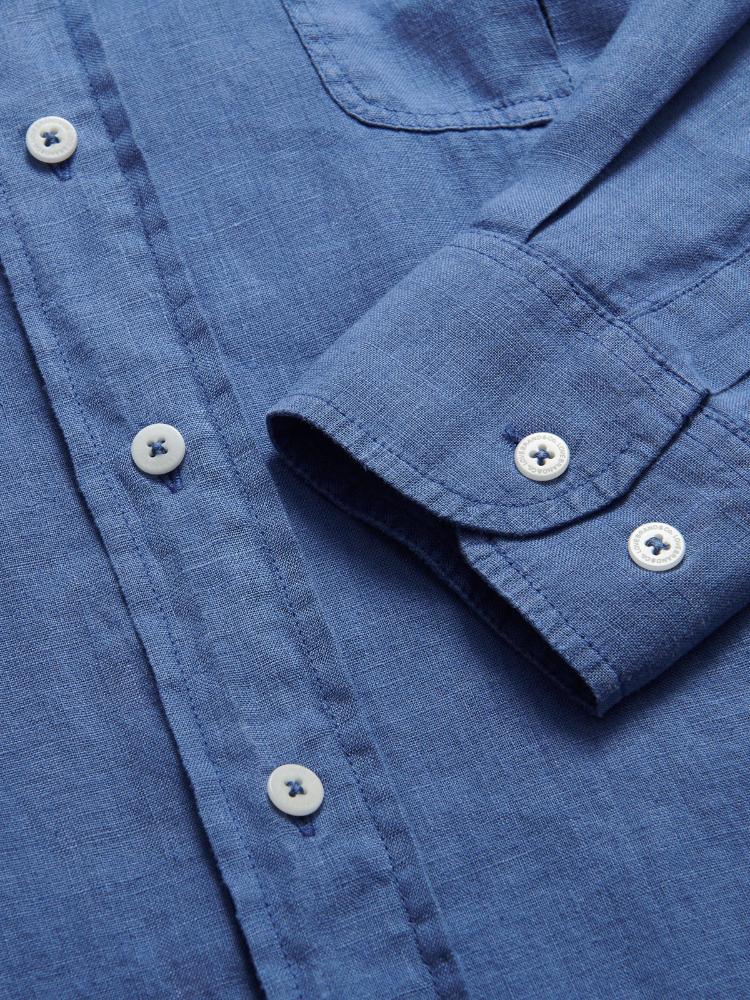 Men's deep blue Andros hemp shirt close-up showing buttons and fabric texture.