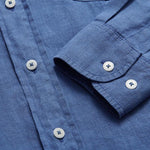 Men's deep blue Andros hemp shirt close-up showing buttons and fabric texture.