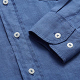 Men's deep blue Andros hemp shirt close-up showing buttons and fabric texture.