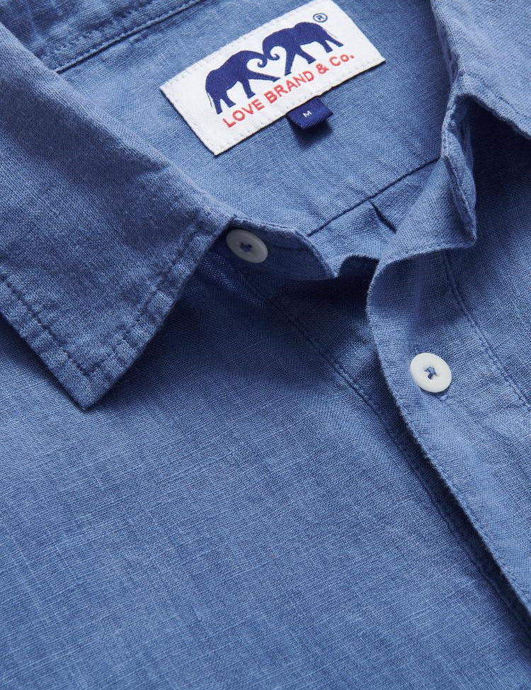 Men's Deep Blue Hoffman Linen Shirt made from 100% natural linen, showcasing a classic collar and white buttons with a brand label.