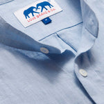 Close-up view of the Men's Elephant Palace Sky Maycock Linen Shirt showcasing the collar, buttons, and the Love Brand & Co. label with an elephant design.