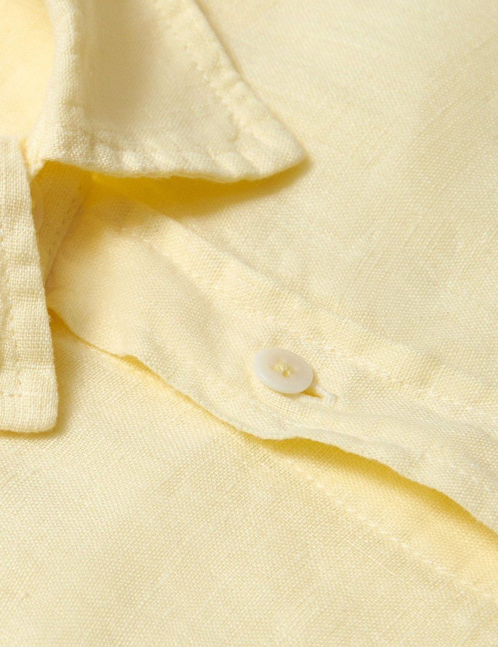 Close-up view of the Men's Limoncello Abaco Linen Shirt showcasing the lightweight, 100% linen fabric in a vibrant yellow hue, highlighting the classic button and collar detail.