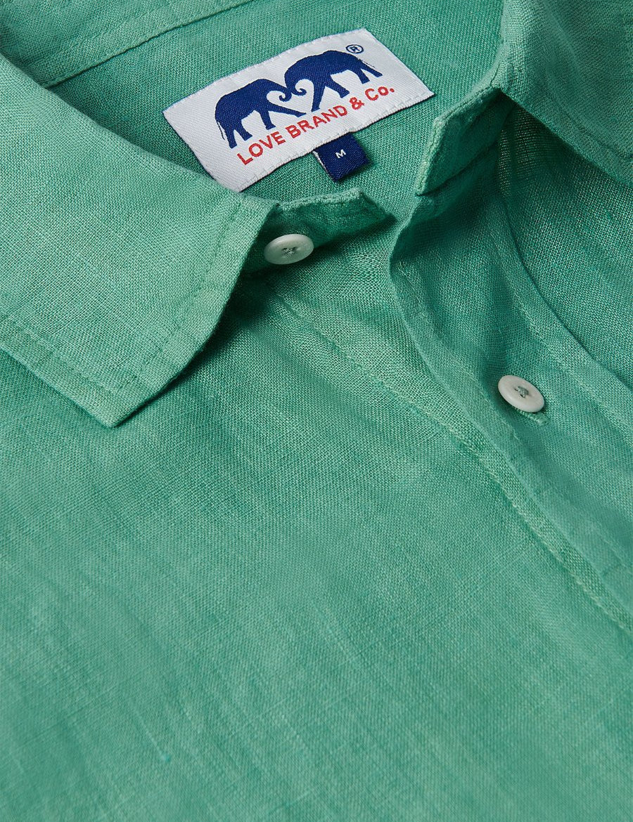 Men's Riviera Green Abaco Linen Shirt close-up showing collar, buttons, and Love Brand & Co. label. One of our old money shirts crafted from 100% linen.