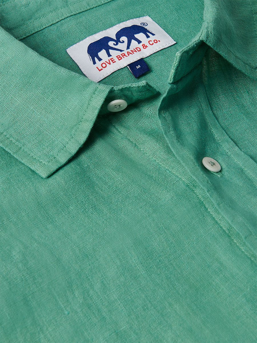 Men's Riviera Green Abaco Linen Shirt close-up showing collar, buttons, and Love Brand & Co. label. One of our old money shirts crafted from 100% linen.