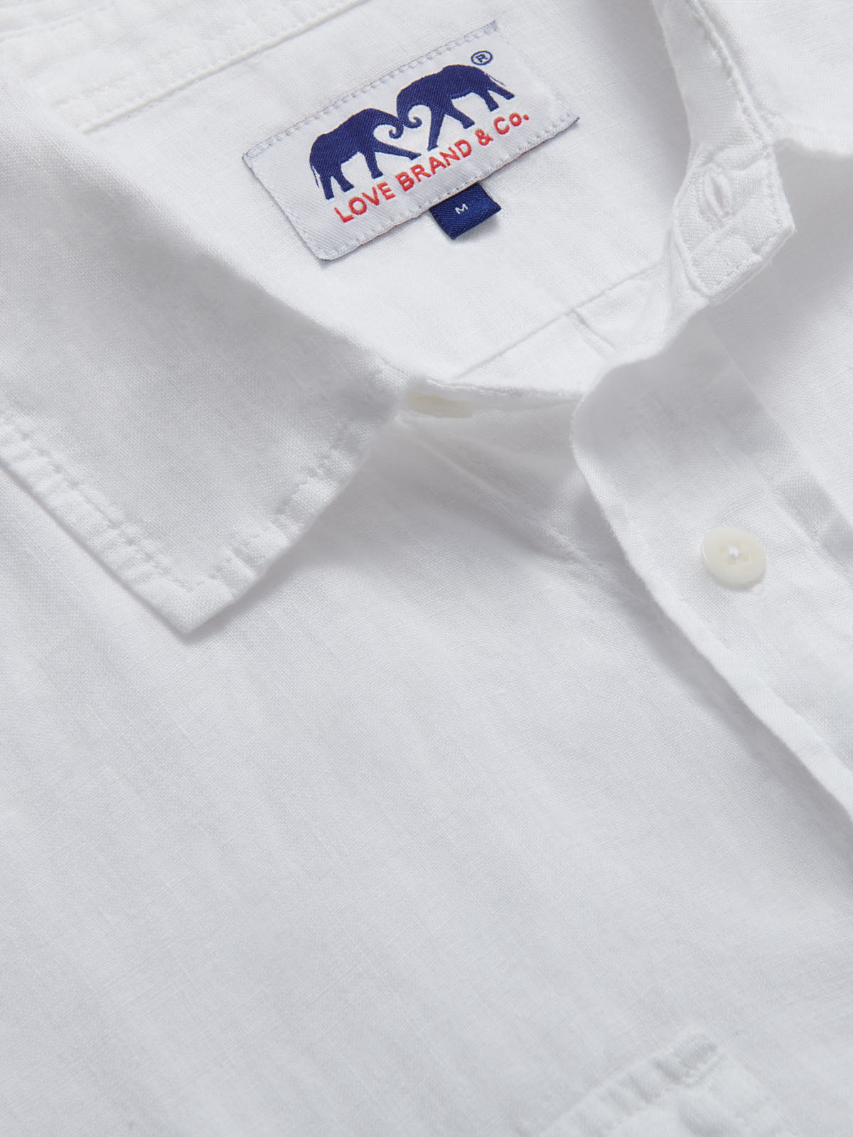 Close-up of Men's White Andros Hemp Shirt showing detailed stitching, a collar, and the "Love Brand & Co." label.