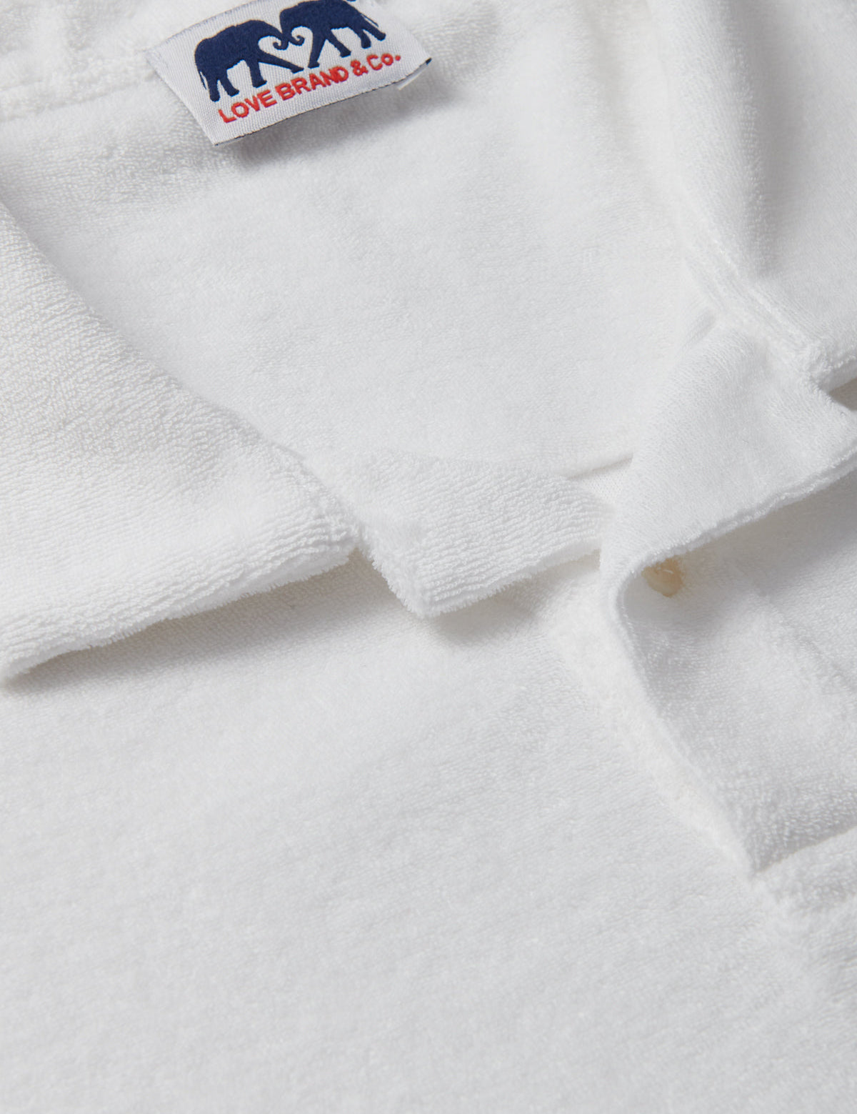 Mens White Terry towelling Polo Shirt close-up of cotton terry towelling fabric.