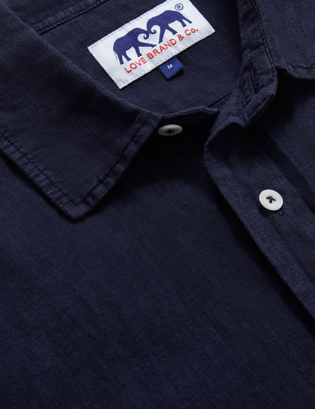 Navy Blue Manjack mens Linen Shirt close-up showing collar, buttons, and Love Brand & Co. label. Old money shirts crafted from 100% linen.