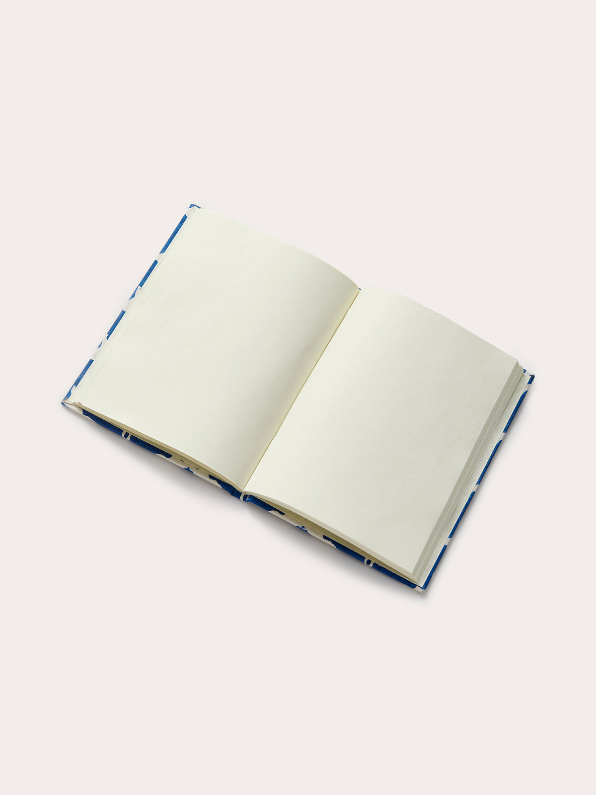 An open notebook made from recycled paper on a white background