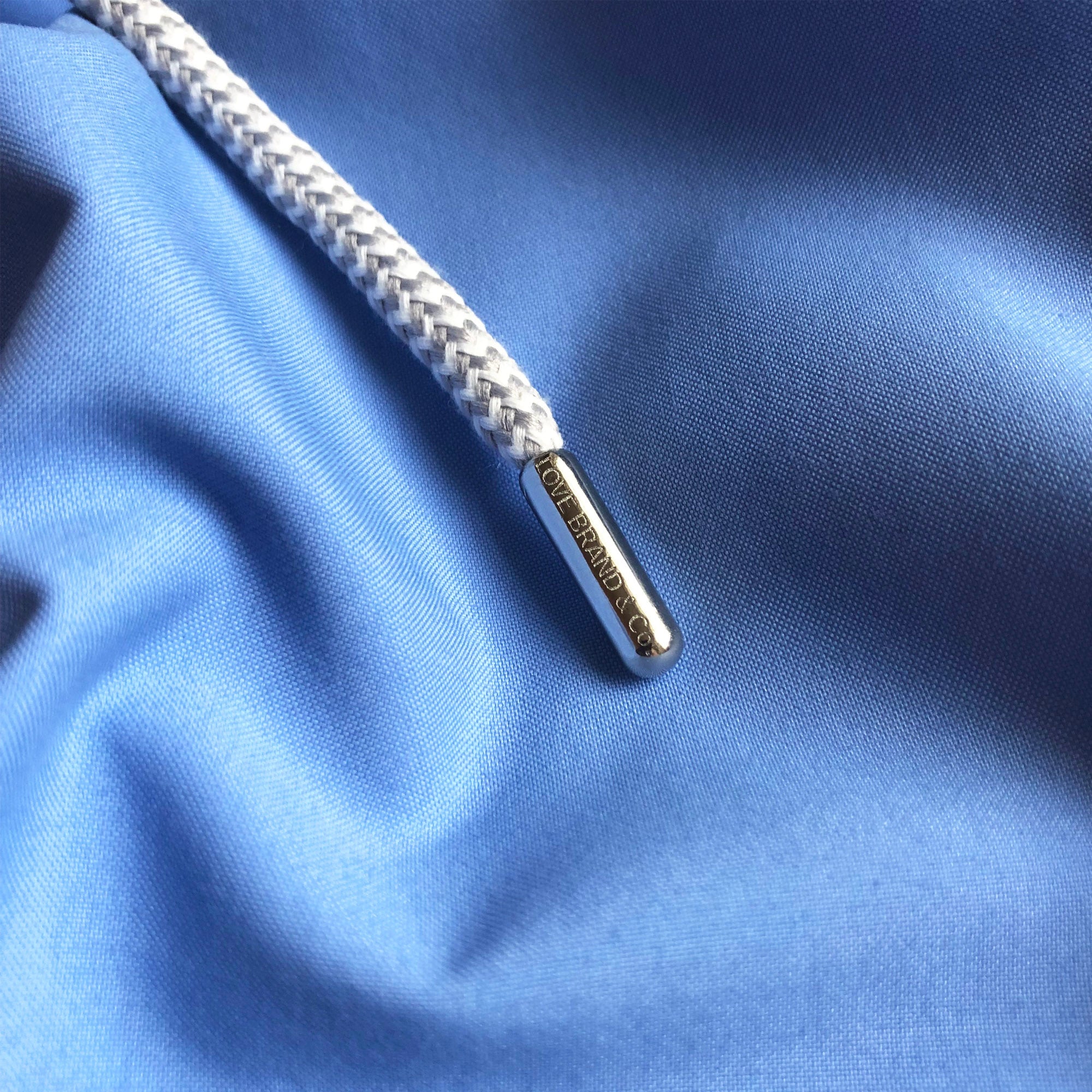 Close-up view of the drawstring and fabric on Boys Ocean Blue Staniel Swim Shorts.