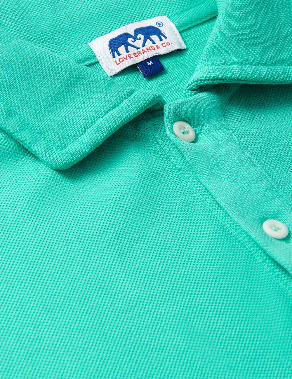 Close-up of Men's Sicilian Green Pensacola Polo Shirt showcasing the collar, buttons, and texture.