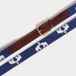 Blue needlepoint belt featuring Asian elephants with trunks up, crafted by B-Corp artisans in Haiti, with genuine leather and a solid brass buckle.