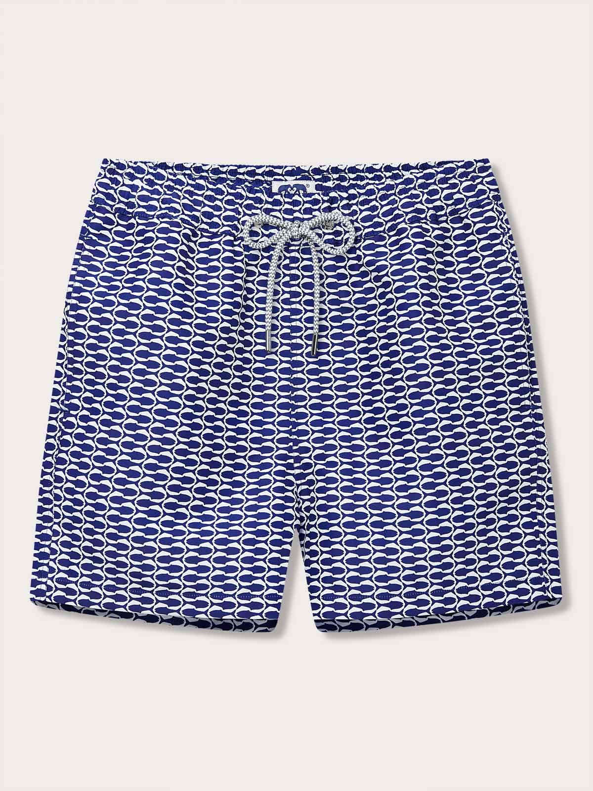 Men's Pine Cay Fish Staniel Swim Shorts. Blue patterned swim shorts featuring a blue and white geometric fish pattern with a drawstring waistband.