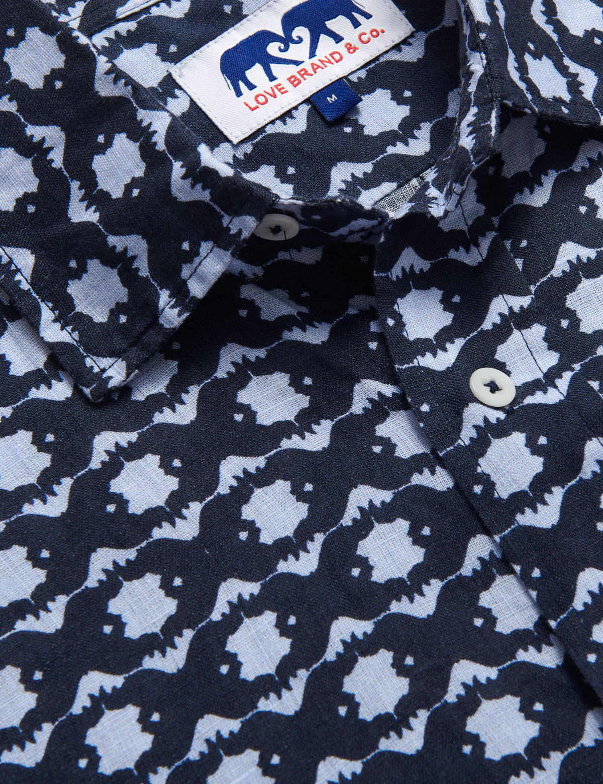 close-up view Rhino Rhythm Abaco mens Linen Shirt. Showingcasing blue rhino pattern.