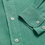 Close-up of the Men's Riviera Green Abaco Linen Shirt showcasing the breathable linen fabric, buttons, and cuff detail. One of our old money shirts crafted from 100% linen.