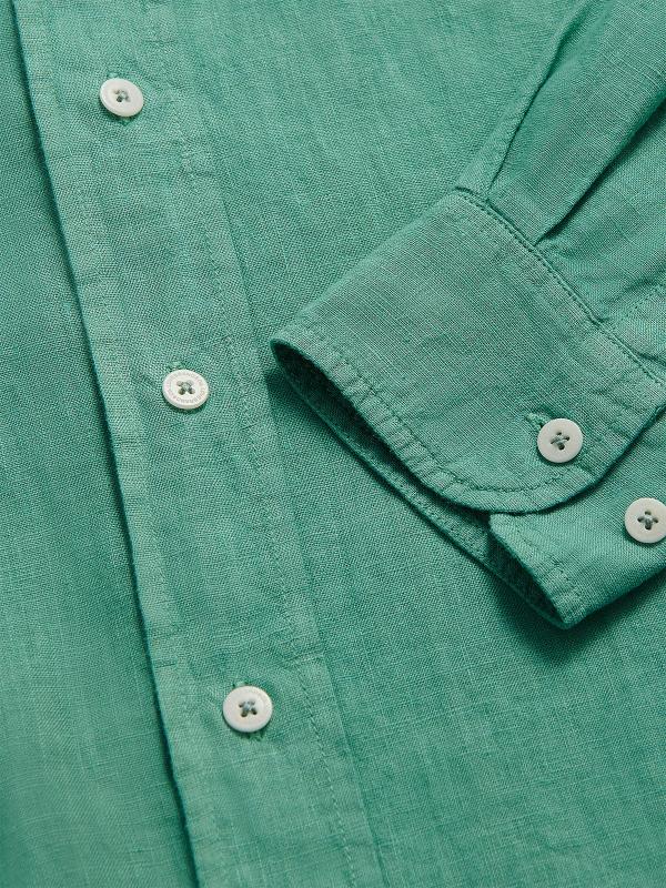 Close-up of the Men's Riviera Green Abaco Linen Shirt showcasing the breathable linen fabric, buttons, and cuff detail. One of our old money shirts crafted from 100% linen.