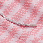 Close-up of the patterned fabric and drawstring detail of the Men's Roseate Spoonbill Staniel Swim Shorts. Patterned swim shorts showcasing a pink and white design inspired by the graceful motion of the roseate spoonbill. Made from 100% recycled, quick-drying fabric for comfort and style.