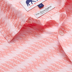 Close-up of Roseate Spoonbill Abaco men's Linen Shirt displaying a vibrant pink pattern featuring the Roseate Spoonbill bird and tags from LOVE BRAND & Co. and The Boca Raton. Old money shirts made from 100% linen.