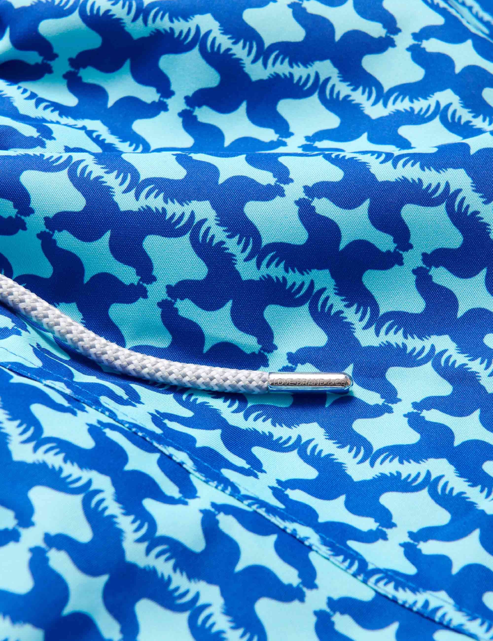 Close-up of Men's Blue Rooster Staniel Swim Shorts showcasing the unique blue and aqua rooster pattern.