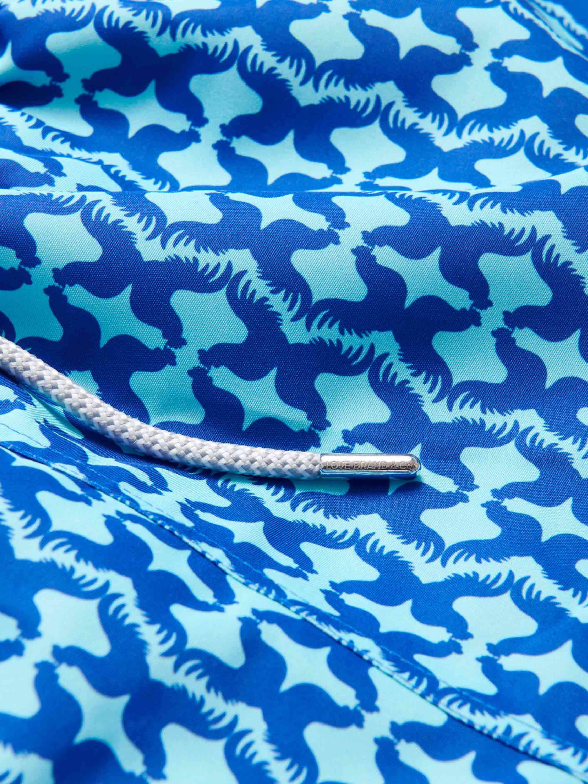 Close-up of Men's Blue Rooster Staniel Swim Shorts showcasing the unique blue and aqua rooster pattern.