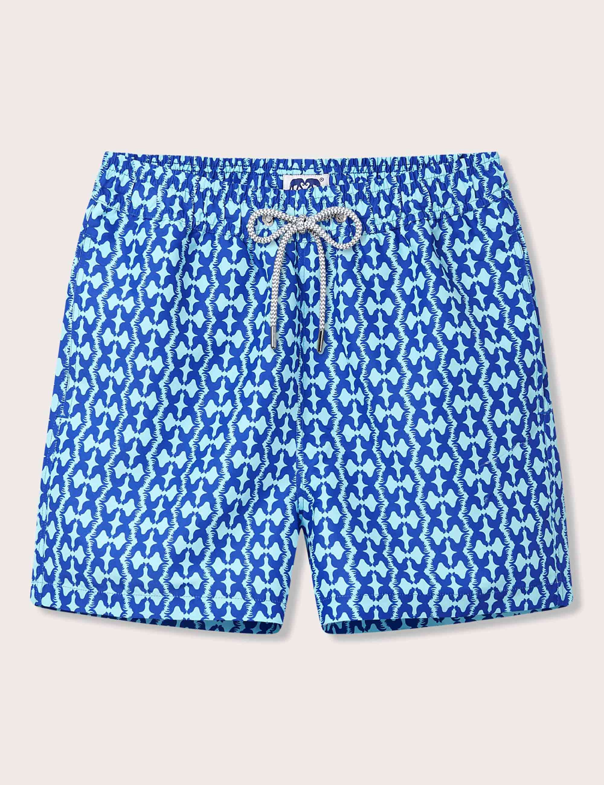 Men's Blue Rooster Staniel Swim Shorts featuring a blue and aqua rooster pattern. Patterned swim shorts designed in collaboration with the Blue Rooster beach shop in Harbour Island, The Bahamas.