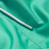 Close-up of Men's Sicilian Green Staniel Swim Shorts in vibrant green fabric showing a white drawstring with silver aglet.