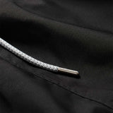 Close-up view of the Men's Volcanic Black Staniel Swim Shorts showing detailed texture and drawstring.