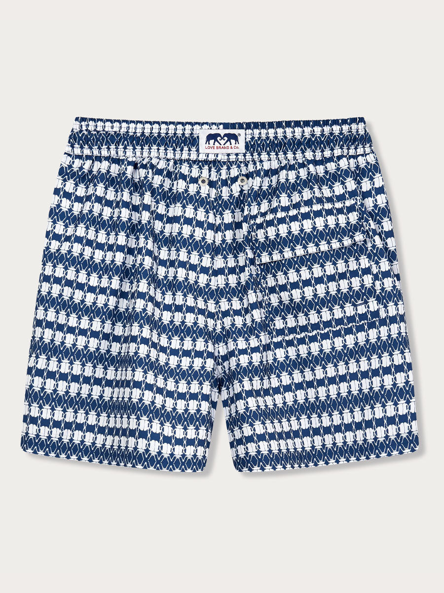 Men's The Beetles Staniel Swim Shorts featuring a mesmerizing white beetle print on deep blue fabric, inspired by the threatened Tansy Beetles.