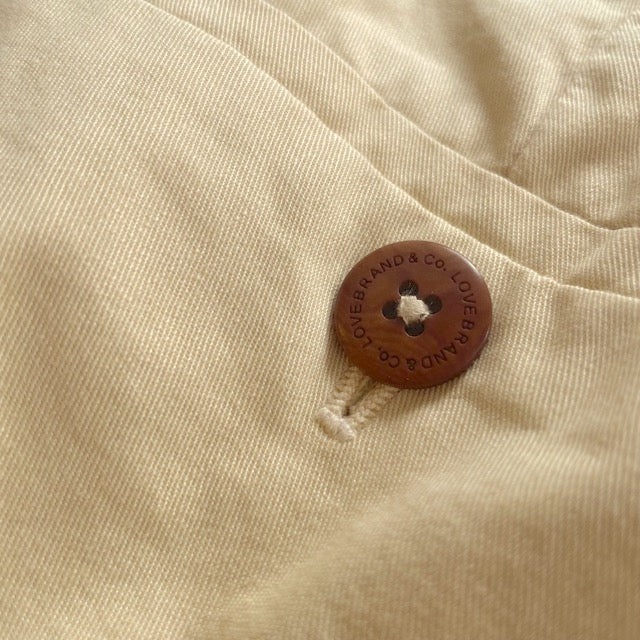 Close-up of Men's Stone Harvey Cotton Shorts showcasing soft-touch organic cotton twill fabric and a signature corozo nut button.