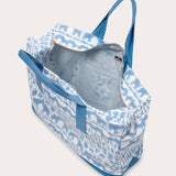 Sky blue canvas tote bag featuring Coexist animal print, open view showing interior pockets, and blue straps.