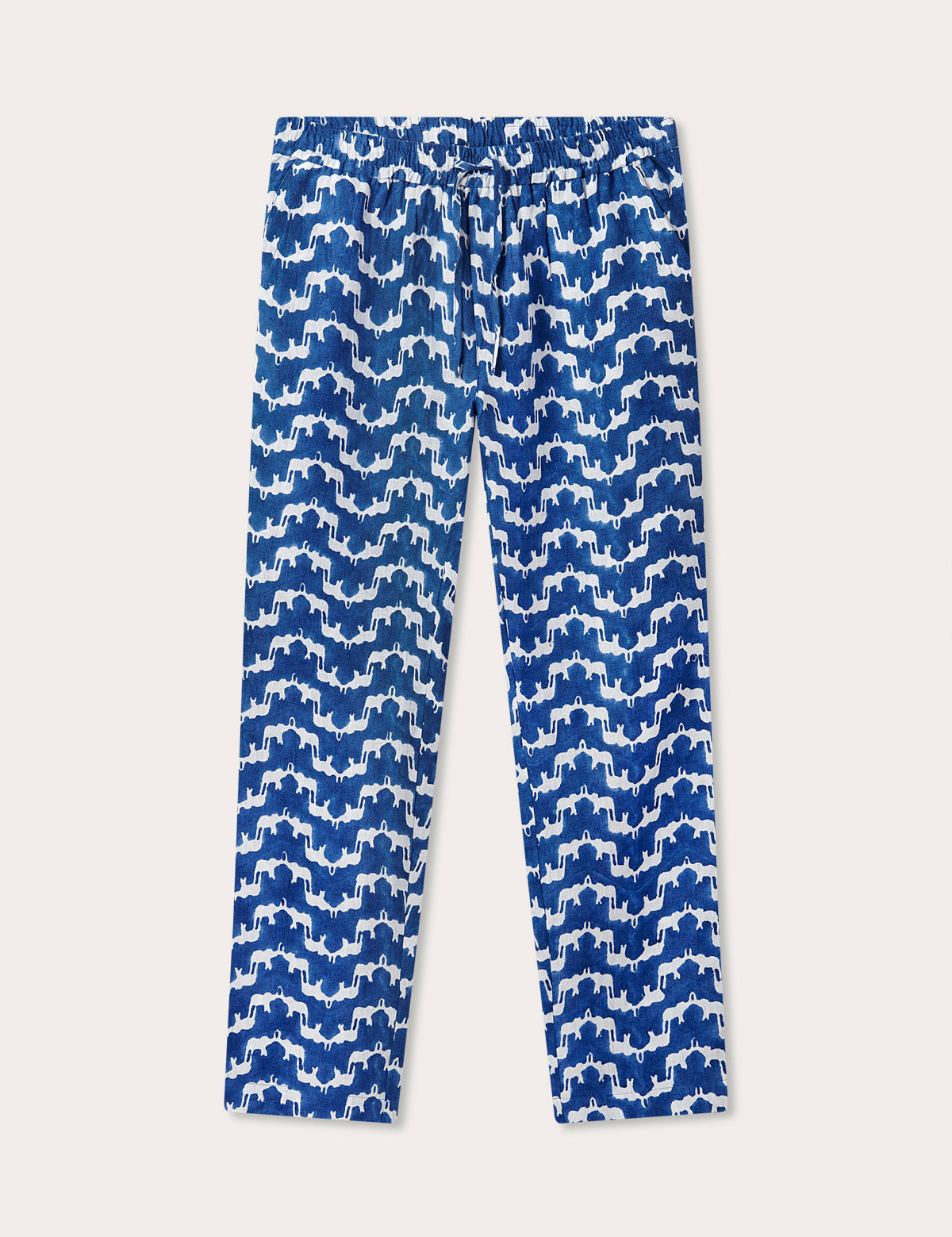 Navy blue linen trousers featuring a blue and white block print pattern of Asian elephants forming an illusion of Indian palaces. Blue linen trousers mens made from 100% premium Belgian linen with an elastic waist and drawstring.