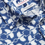 Close-up of Men's White Heron Abaco Linen Shirt. White and navy men's linen shirt featuring heron print design with Love Brand and The Boca Raton labels.