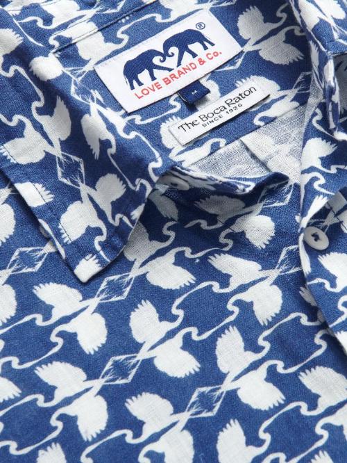 Close-up of Men's White Heron Abaco Linen Shirt. White and navy men's linen shirt featuring heron print design with Love Brand and The Boca Raton labels.