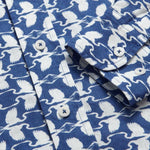 Close-up of Men's White Heron Abaco Linen Shirt featuring a deep blue background with white heron prints. Old money shirt designed for The Boca Raton by LOVE BRAND & Co.