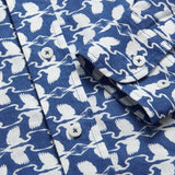 Close-up of Men's White Heron Abaco Linen Shirt featuring a deep blue background with white heron prints. Old money shirt designed for The Boca Raton by LOVE BRAND & Co.