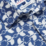 Close-up of the Men's White Heron Manjack Linen Shirt, showcasing its blue and white pattern featuring the Great White Heron. Men's linen shirt crafted from 100% linen with a button-up short-sleeved design.