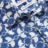 Close-up of the Men's White Heron Manjack Linen Shirt, showcasing its blue and white pattern featuring the Great White Heron. Men's linen shirt crafted from 100% linen with a button-up short-sleeved design.