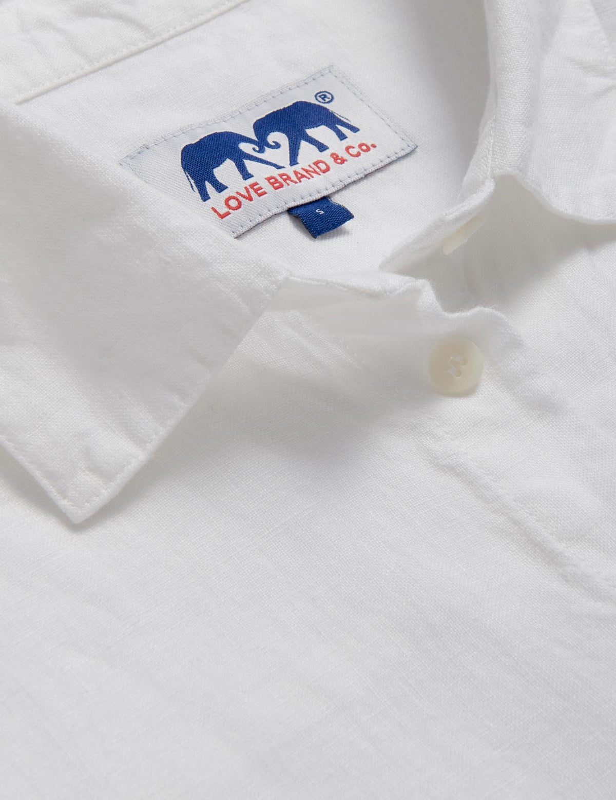 Detailed view of Womens White Inagua Linen Shirt. Long-sleeved button-up plain linen shirt with front pocket.